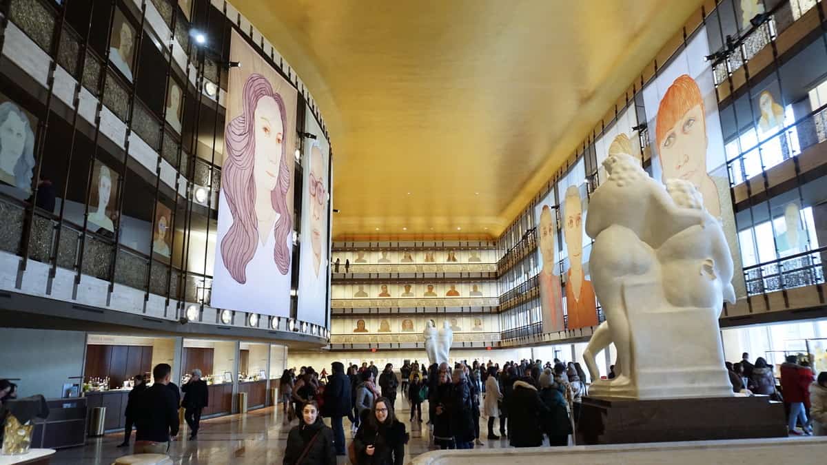 Lincoln Center lobby featuring artwork of the staff at the Lincoln Center - Visiting National Parks in New York - Weekend trip to New York City | Sincerely Yasmin