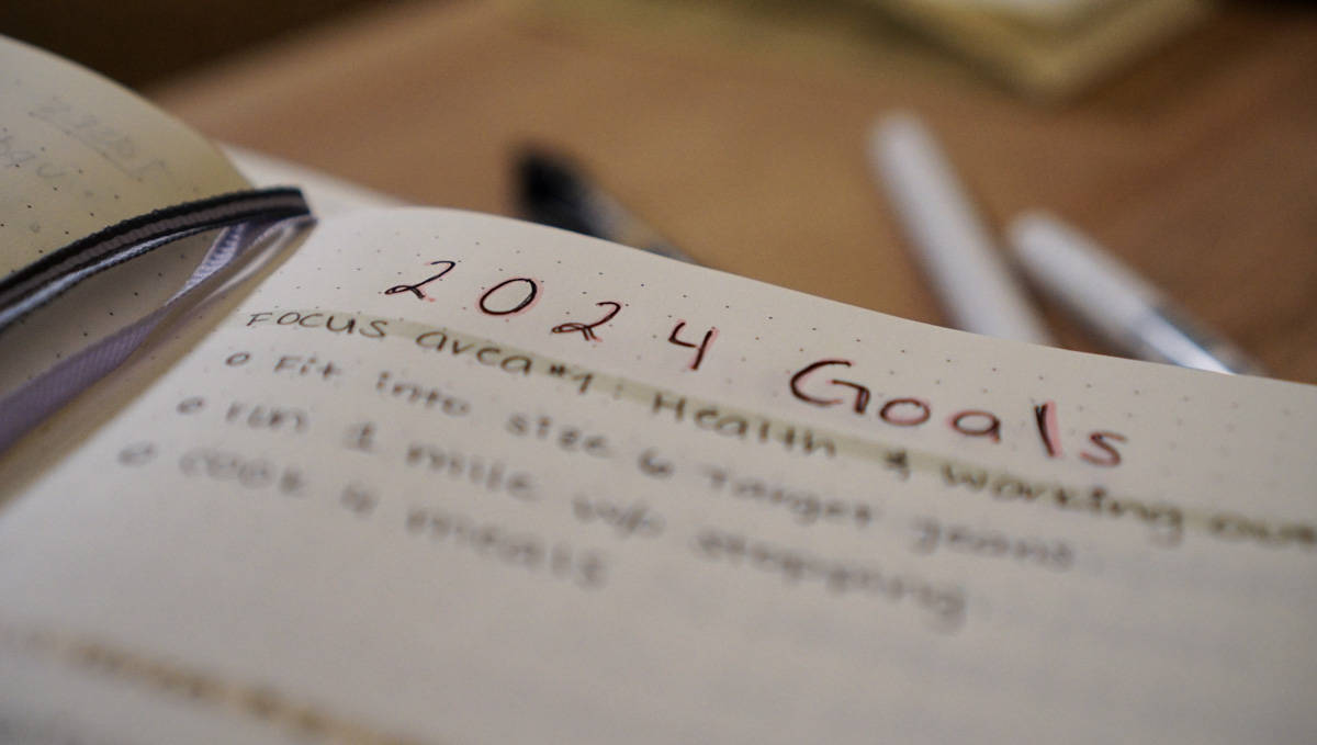 Close-up picture of a Leuchtturm dotted notebook with the words "2024 Goals" written on in in pink marker with black pen over it.